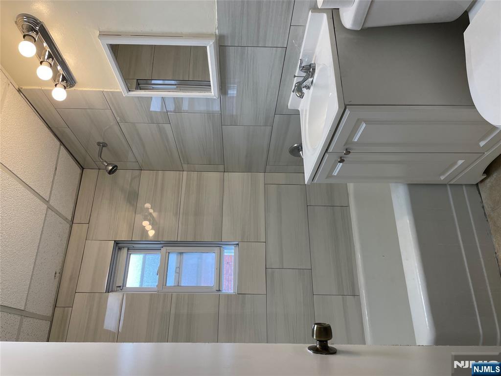 138 Midland Place, Unit 2 Newark, NJ 07106 - Photo 3 of 6 a bathroom with a sink toilet and shower