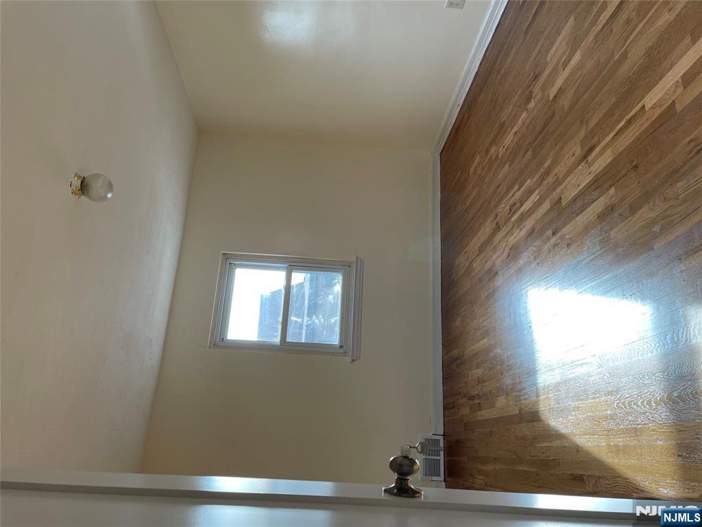 138 Midland Place, Unit 2 Newark, NJ 07106 - Photo 6 of 6 an empty room with wooden floor and windows