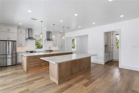 a kitchen with kitchen island stainless steel appliances sink and microwave