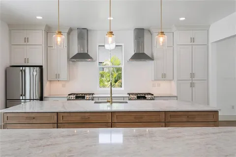 a kitchen with stainless steel appliances granite countertop a stove and a wooden floors