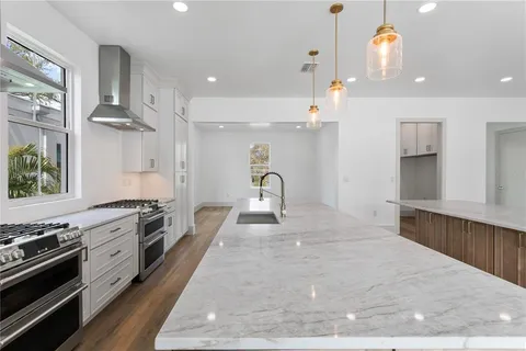 a kitchen with stainless steel appliances a stove a sink and a counter space