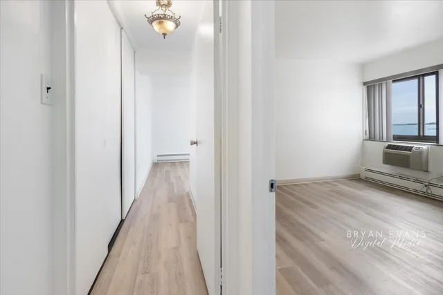 a view of hallway with wooden floor