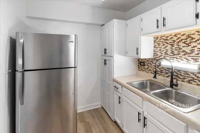 a kitchen with a sink and refrigerator