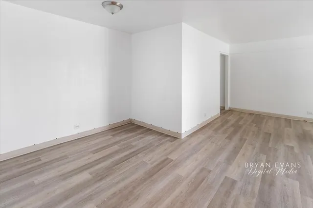 a view of a room with wooden floor