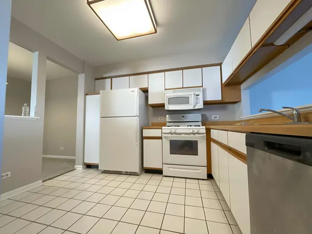 a kitchen with a cabinets and white appliances