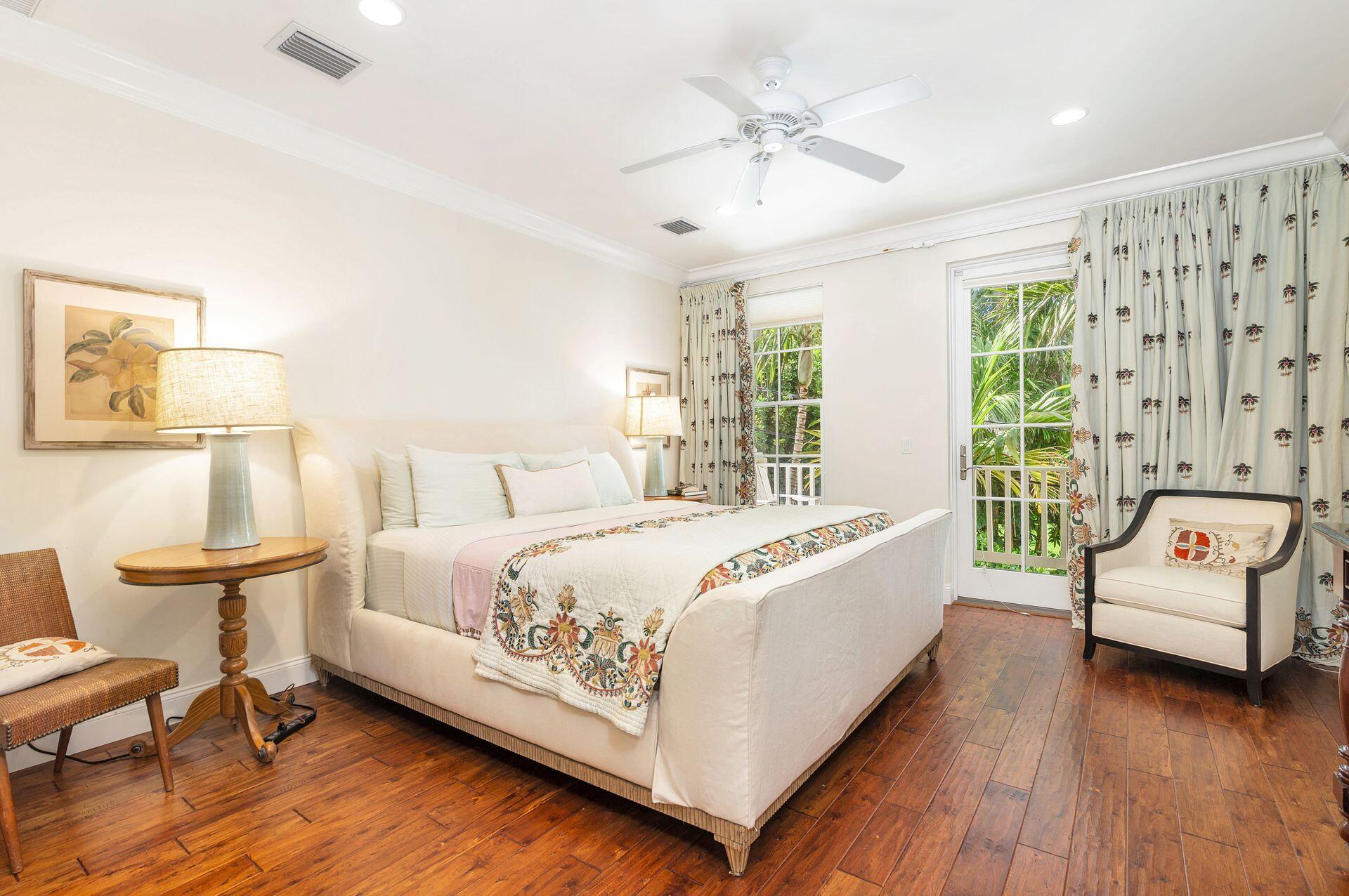 135 Root Trail, Unit A Palm Beach, FL 33480 - Photo 13 of 25 a spacious bedroom with a bed and a chair