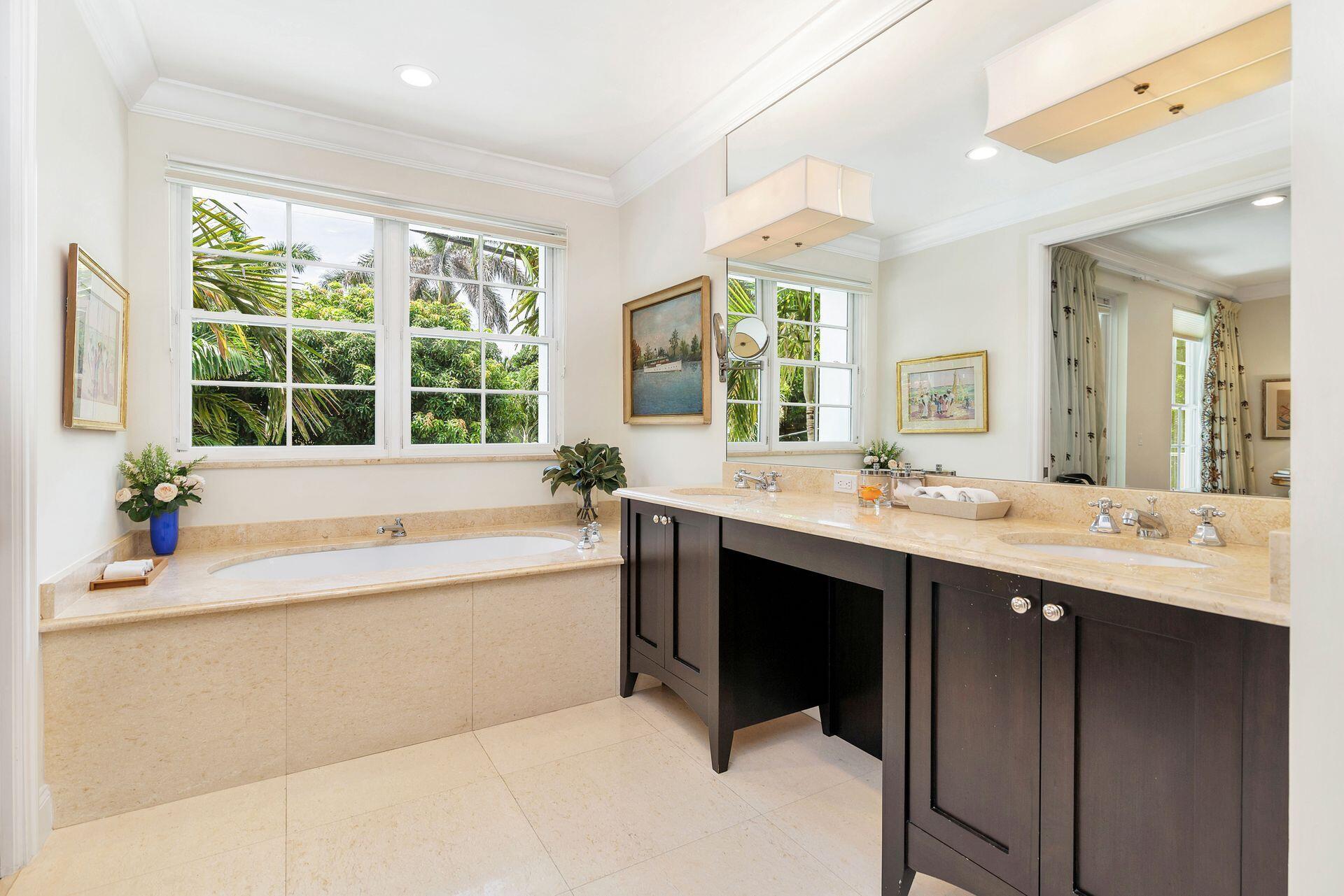 135 Root Trail, Unit A Palm Beach, FL 33480 - Photo 14 of 25 a spacious bathroom with a tub sink and mirror
