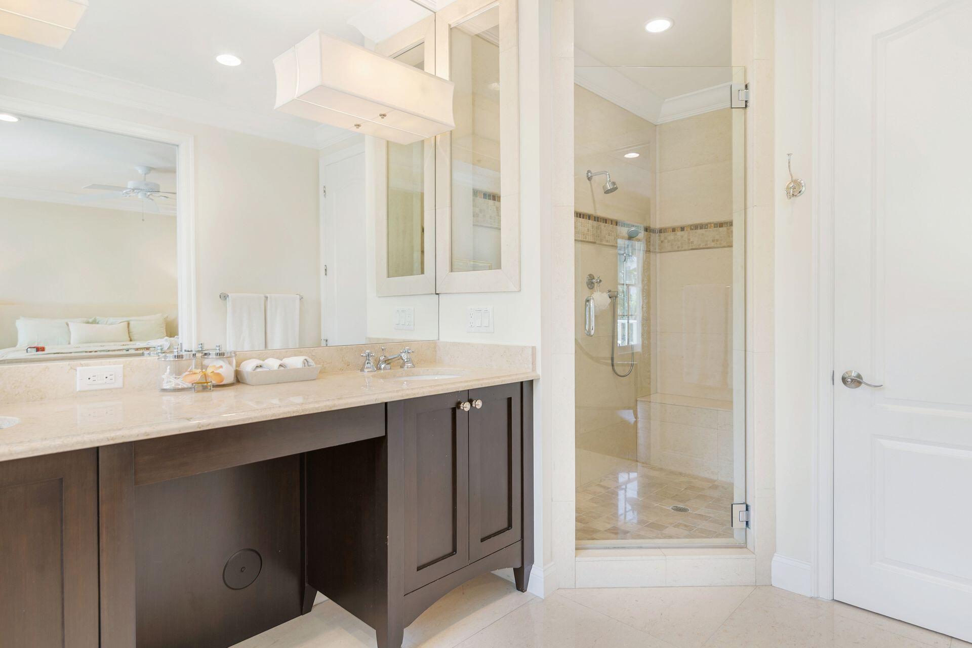 135 Root Trail, Unit A Palm Beach, FL 33480 - Photo 15 of 25 a bathroom with a sink shower and a mirror