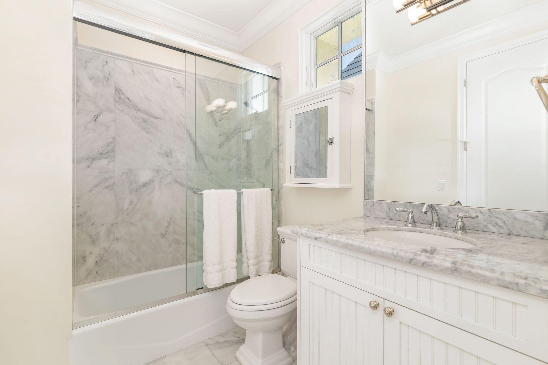 135 Root Trail, Unit A Palm Beach, FL 33480 - Photo 18 of 25 a bathroom with a granite countertop sink toilet and shower