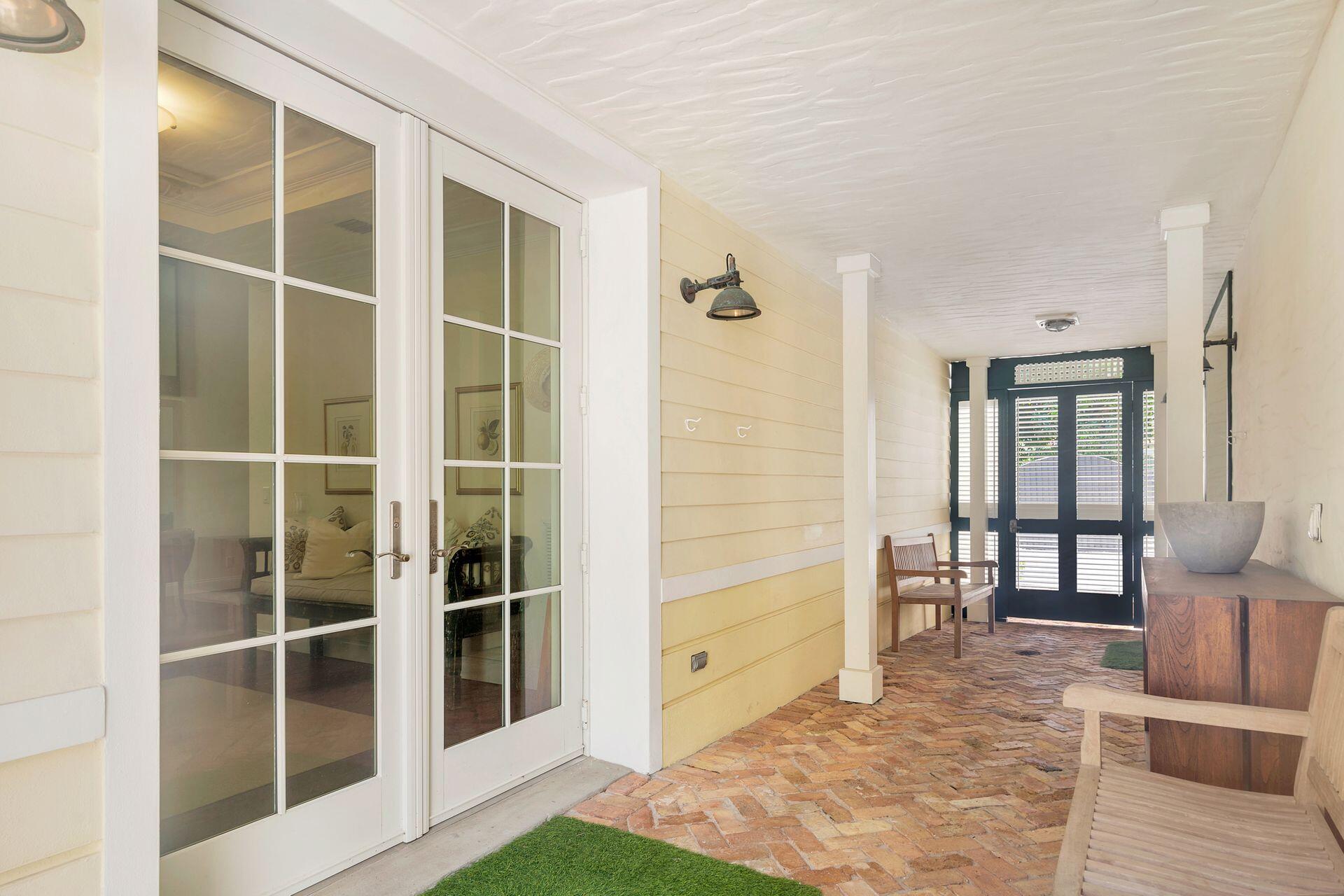 135 Root Trail, Unit A Palm Beach, FL 33480 - Photo 4 of 25 a view of empty room with wooden floor and floor to ceiling window
