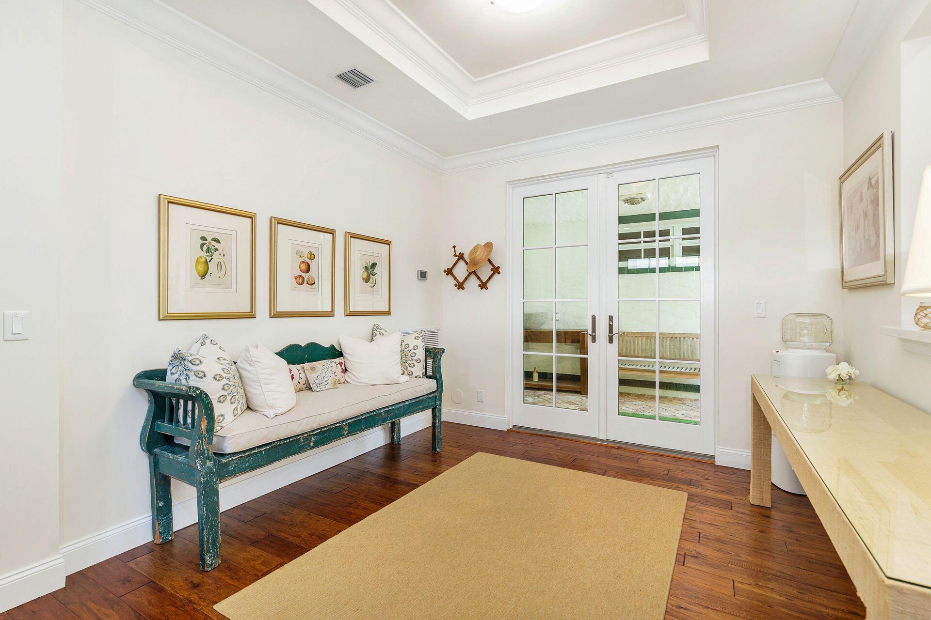 135 Root Trail, Unit A Palm Beach, FL 33480 - Photo 5 of 25 a spacious bedroom with a bed and a couch