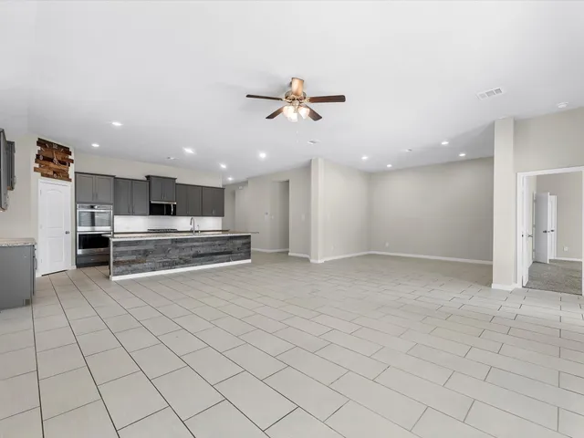 a view of kitchen with refrigerator and cabinets
