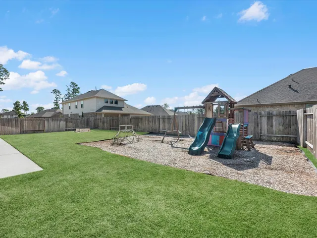 a view of a house with backyard and a slide