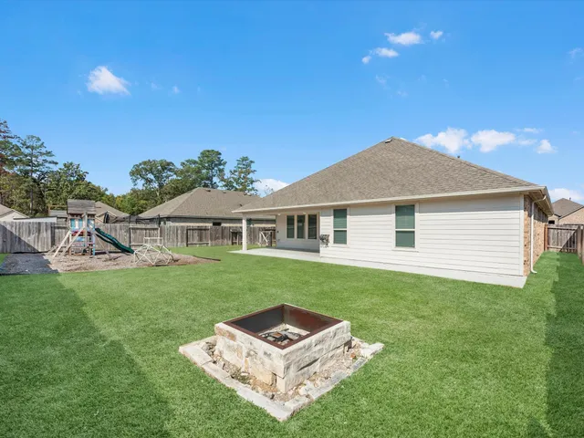 a backyard of a house with table and chairs