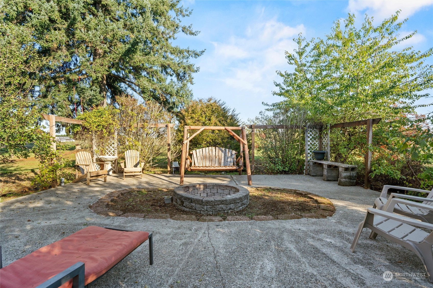 17232 Kaylen Lane Southwest Rochester, WA 98579 - Photo 39 of 40 a backyard of a house with table and chairs