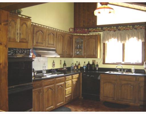 Kitchen. Another view of kitchen showing cathedral ceilings and woodwork.