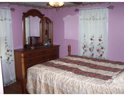 134 Winton Street Springfield, MA 01118 - Photo 7 of 12 a bedroom with a bed and a dresser
