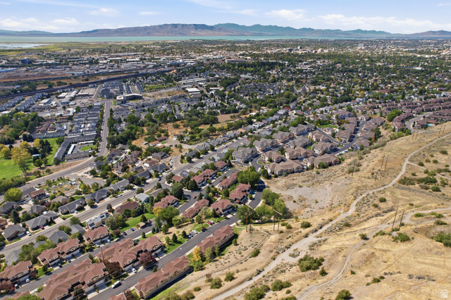 1305 Alpine Way Provo, UT 84606 - Photo 50 of 56 Expansive aerial showing a residential area with varied housing types, green spaces, and a distant body of water