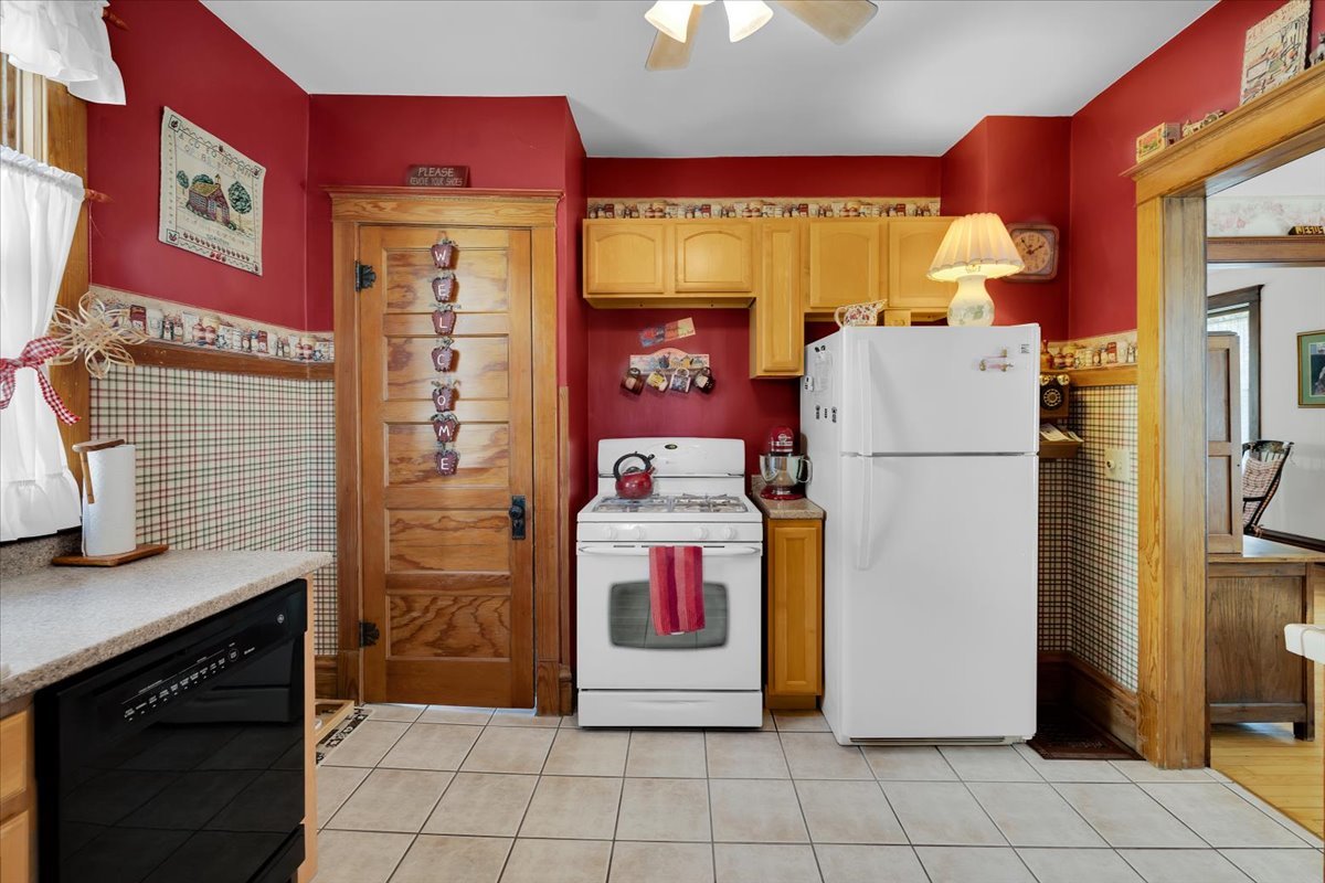 102 Monroe Street Elgin, IL 60123 - Photo 15 of 34 a kitchen with refrigerator and cabinets