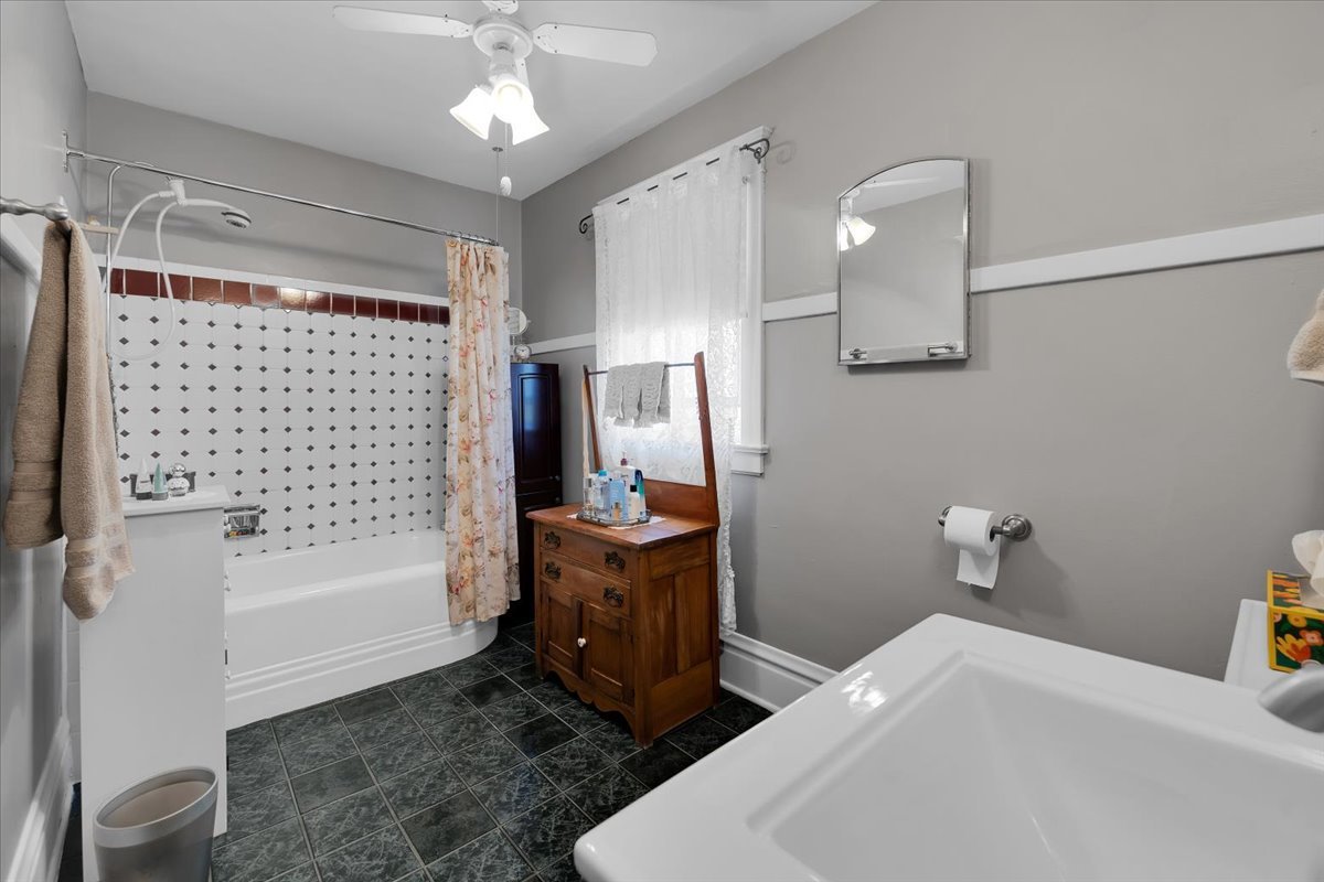 102 Monroe Street Elgin, IL 60123 - Photo 18 of 34 a bathroom with a sink a toilet and shower
