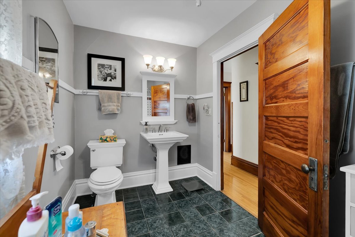 102 Monroe Street Elgin, IL 60123 - Photo 19 of 34 a bathroom with a sink toilet and mirror
