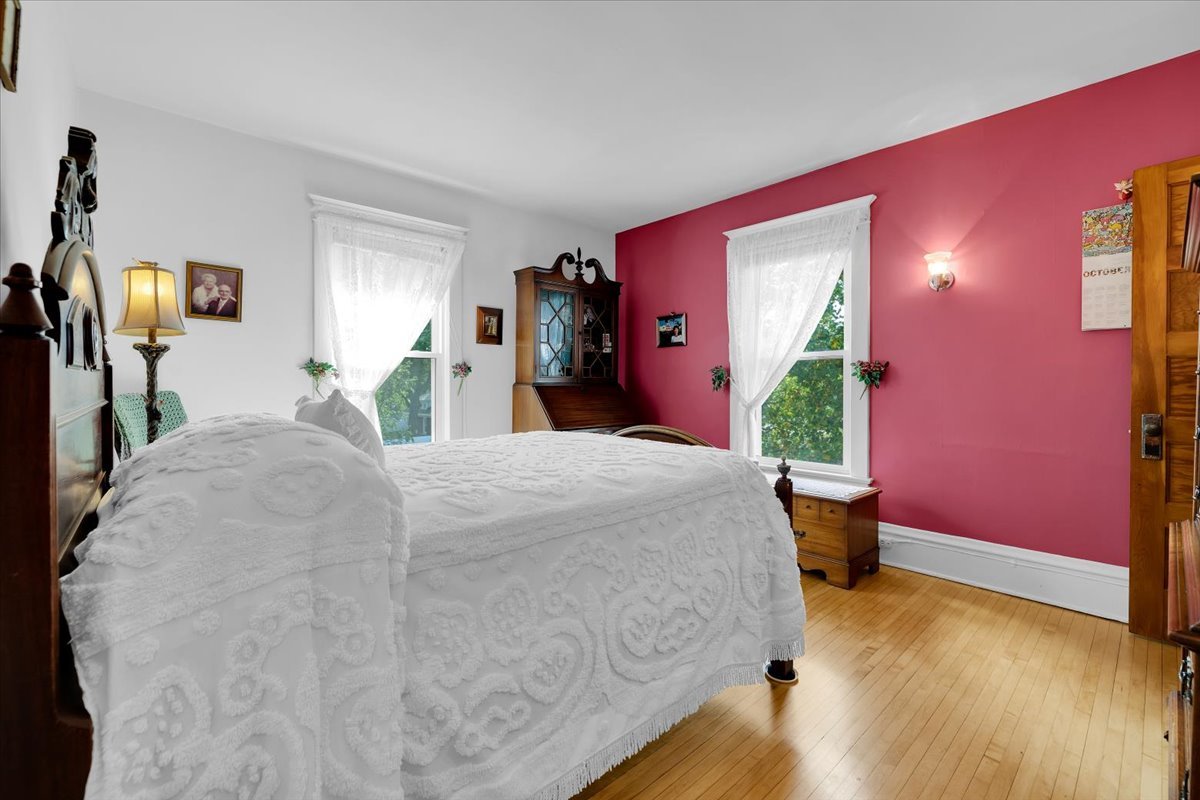 102 Monroe Street Elgin, IL 60123 - Photo 20 of 34 a bed sitting in a spacious bedroom next to a window