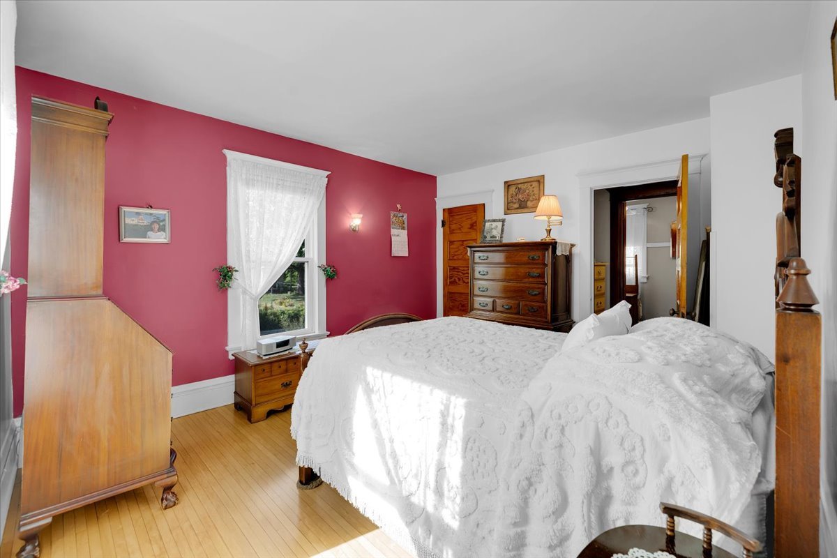 102 Monroe Street Elgin, IL 60123 - Photo 21 of 34 a bed room with a bed and dresser with mirror