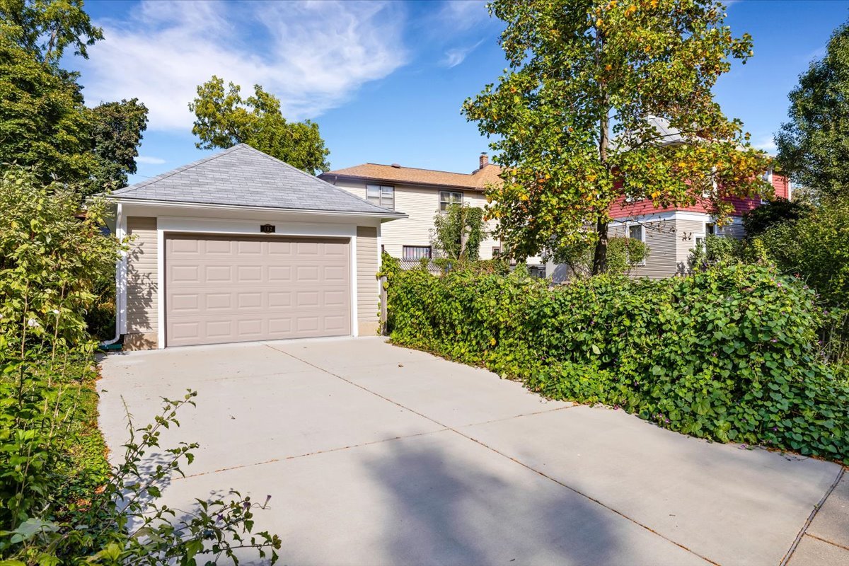 102 Monroe Street Elgin, IL 60123 - Photo 29 of 34 a front view of a house with a yard and garage