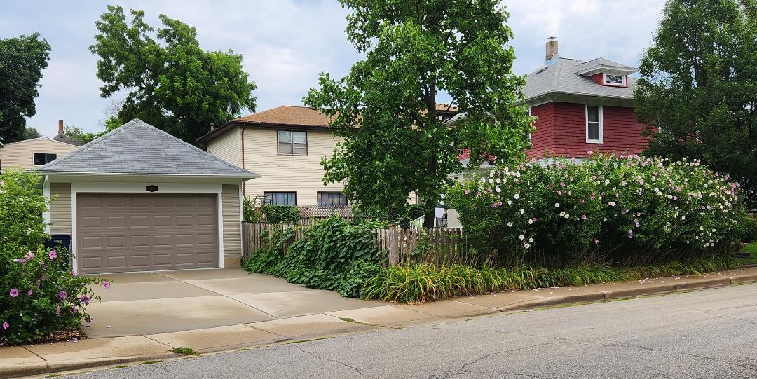 102 Monroe Street Elgin, IL 60123 - Photo 31 of 34 a front view of a house with a garden