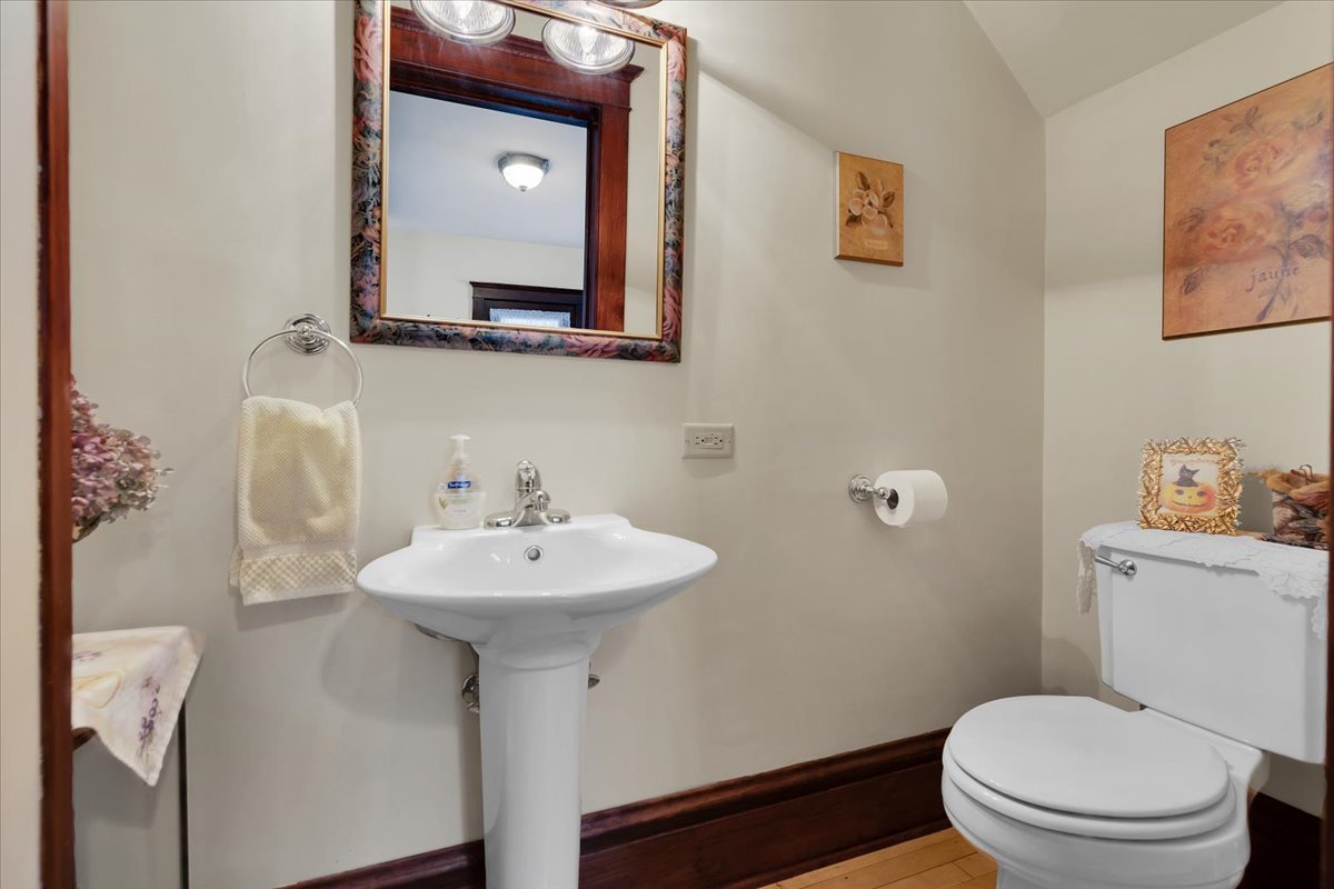 102 Monroe Street Elgin, IL 60123 - Photo 7 of 34 a bathroom with a toilet sink and mirror