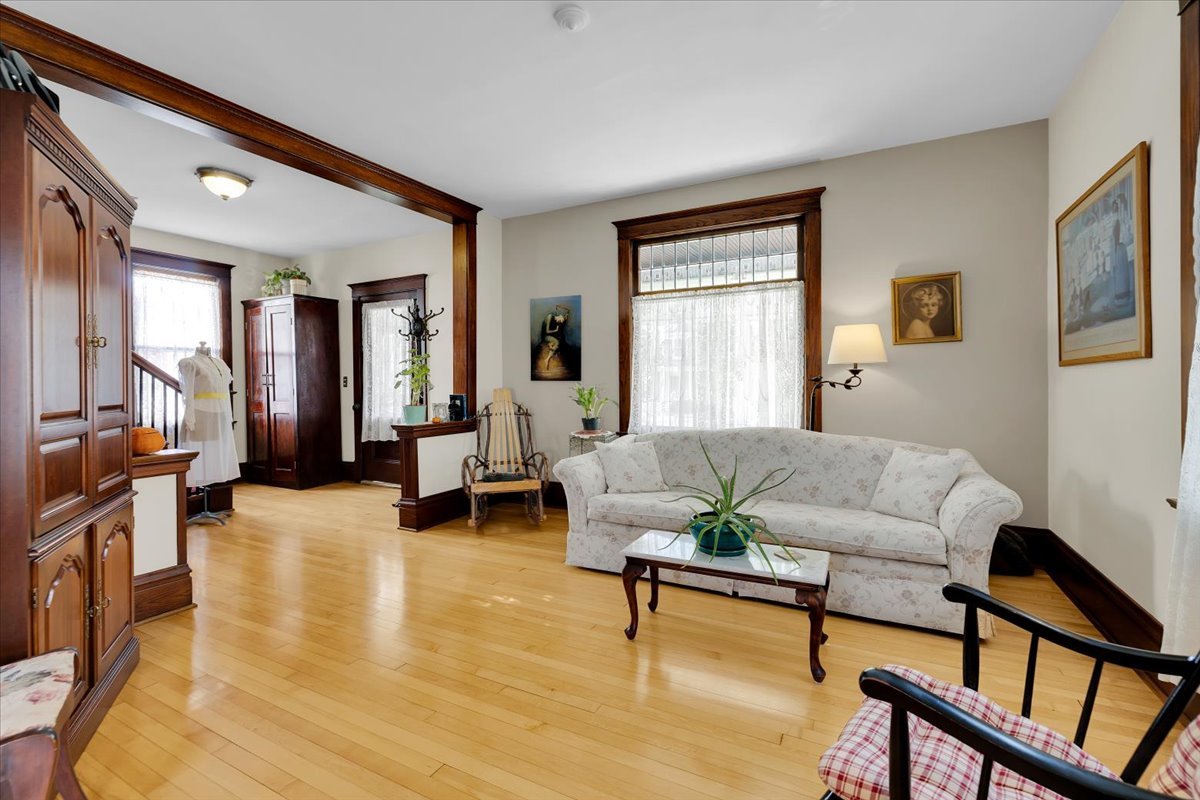 102 Monroe Street Elgin, IL 60123 - Photo 10 of 34 a living room with furniture and a wooden floor