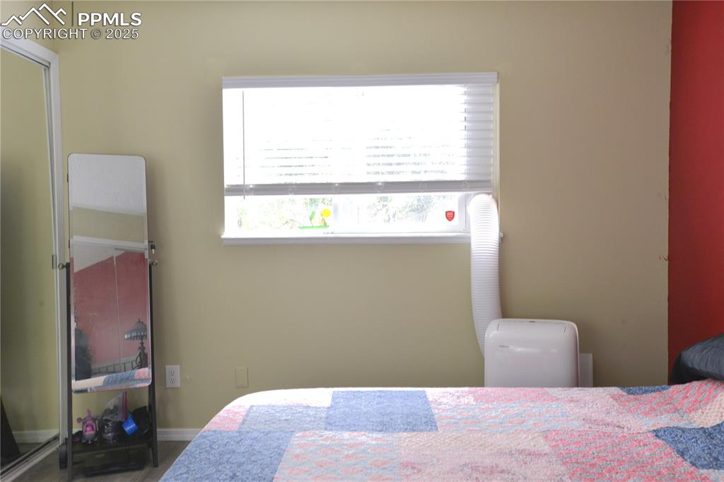575 Blossom Field Road Fountain, CO 80817 - Photo 11 of 24 a bedroom with a bed and a window