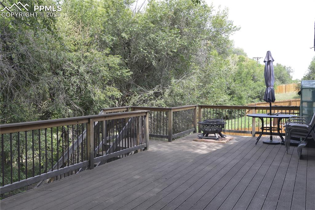 575 Blossom Field Road Fountain, CO 80817 - Photo 14 of 24 a view of a deck with two chairs and wooden floor