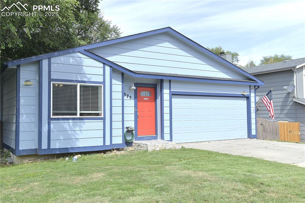 575 Blossom Field Road Fountain, CO 80817 - Photo 2 of 24 a front view of a house with a yard and garage