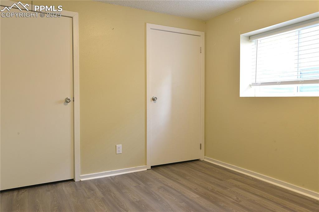 575 Blossom Field Road Fountain, CO 80817 - Photo 23 of 24 a view of an empty room with wooden floor and a window