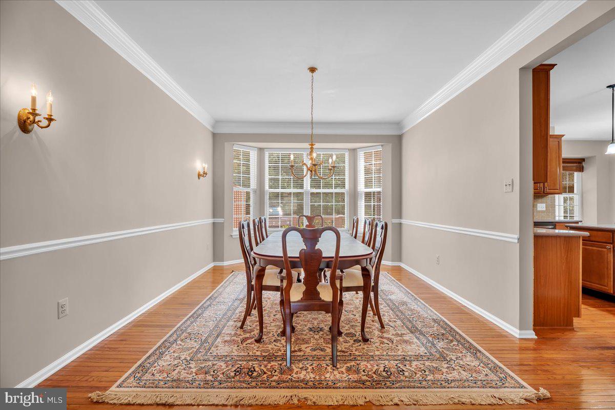 68 Hillside Lane Mount Laurel, NJ 08054 - Photo 8 of 36 a dining room with wooden floor and a rug