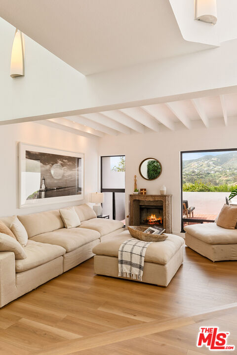 29221 Heathercliff Road, Unit 13 Malibu, CA 90265 - Photo 11 of 43 a living room with furniture windows and a fireplace