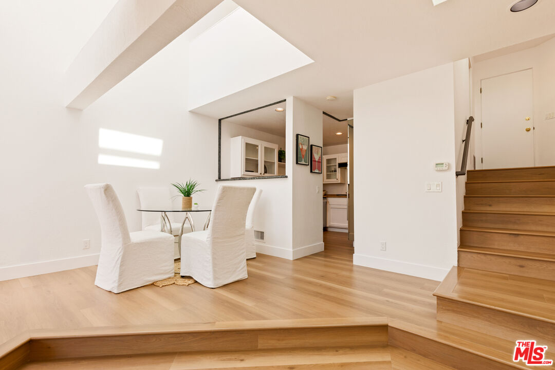 29221 Heathercliff Road, Unit 13 Malibu, CA 90265 - Photo 14 of 43 a white room with wooden floor and furniture
