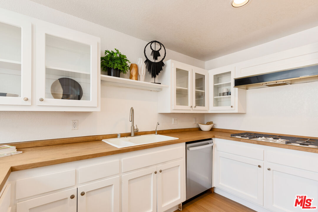 29221 Heathercliff Road, Unit 13 Malibu, CA 90265 - Photo 15 of 43 a kitchen with a sink and cabinets