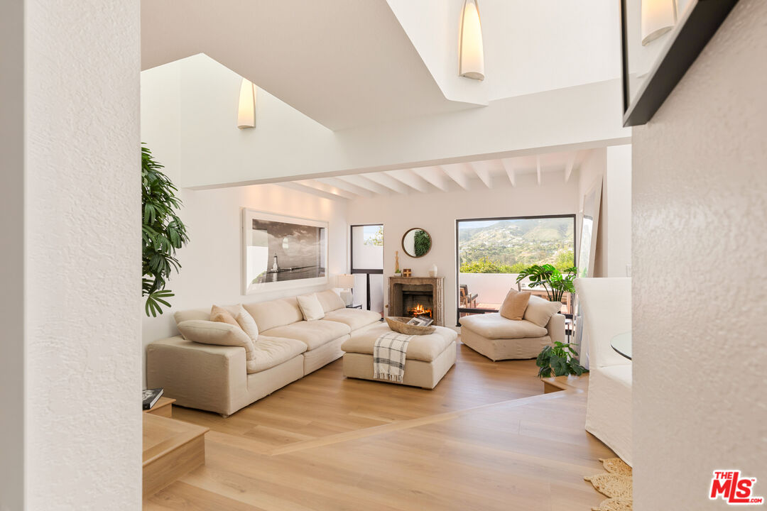 29221 Heathercliff Road, Unit 13 Malibu, CA 90265 - Photo 16 of 43 a living room with furniture and a large window