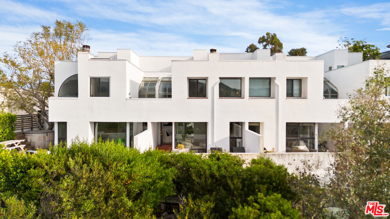 29221 Heathercliff Road, Unit 13 Malibu, CA 90265 - Photo 23 of 43 a view of a building with a yard
