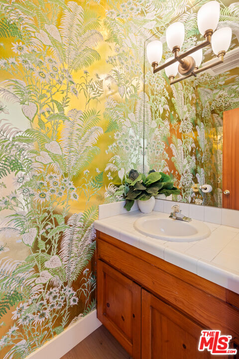 29221 Heathercliff Road, Unit 13 Malibu, CA 90265 - Photo 24 of 43 a bathroom with a sink and a mirror