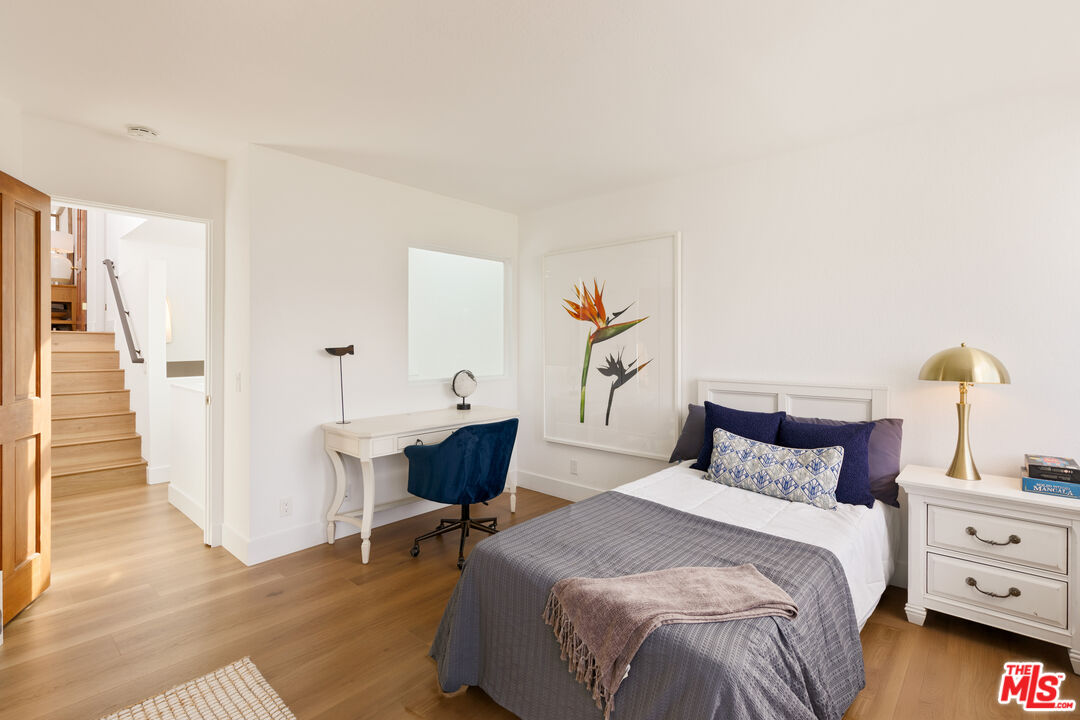29221 Heathercliff Road, Unit 13 Malibu, CA 90265 - Photo 29 of 43 a bedroom with a bed and a table
