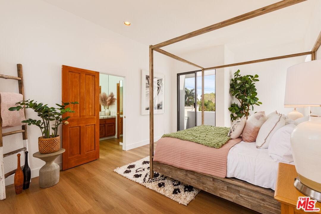 29221 Heathercliff Road, Unit 13 Malibu, CA 90265 - Photo 33 of 43 a bedroom with a bed and a potted plant