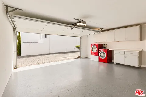 a view of a storage & utility room with a washer dryer