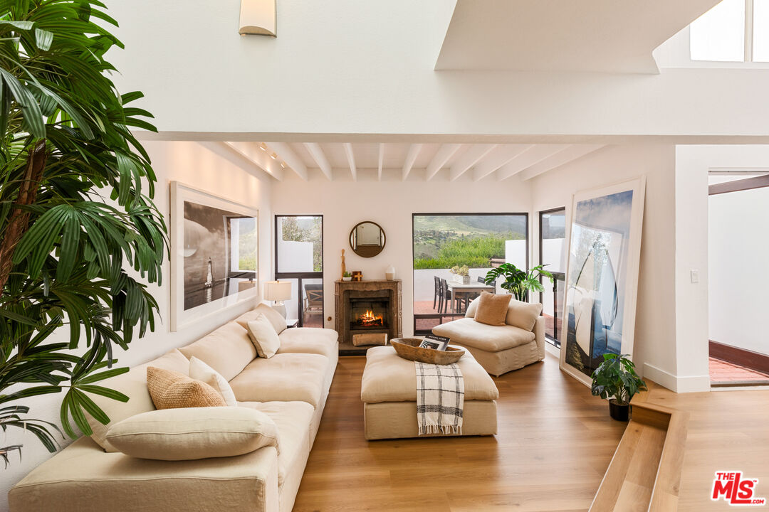 29221 Heathercliff Road, Unit 13 Malibu, CA 90265 - Photo 9 of 43 a living room with furniture and a large window