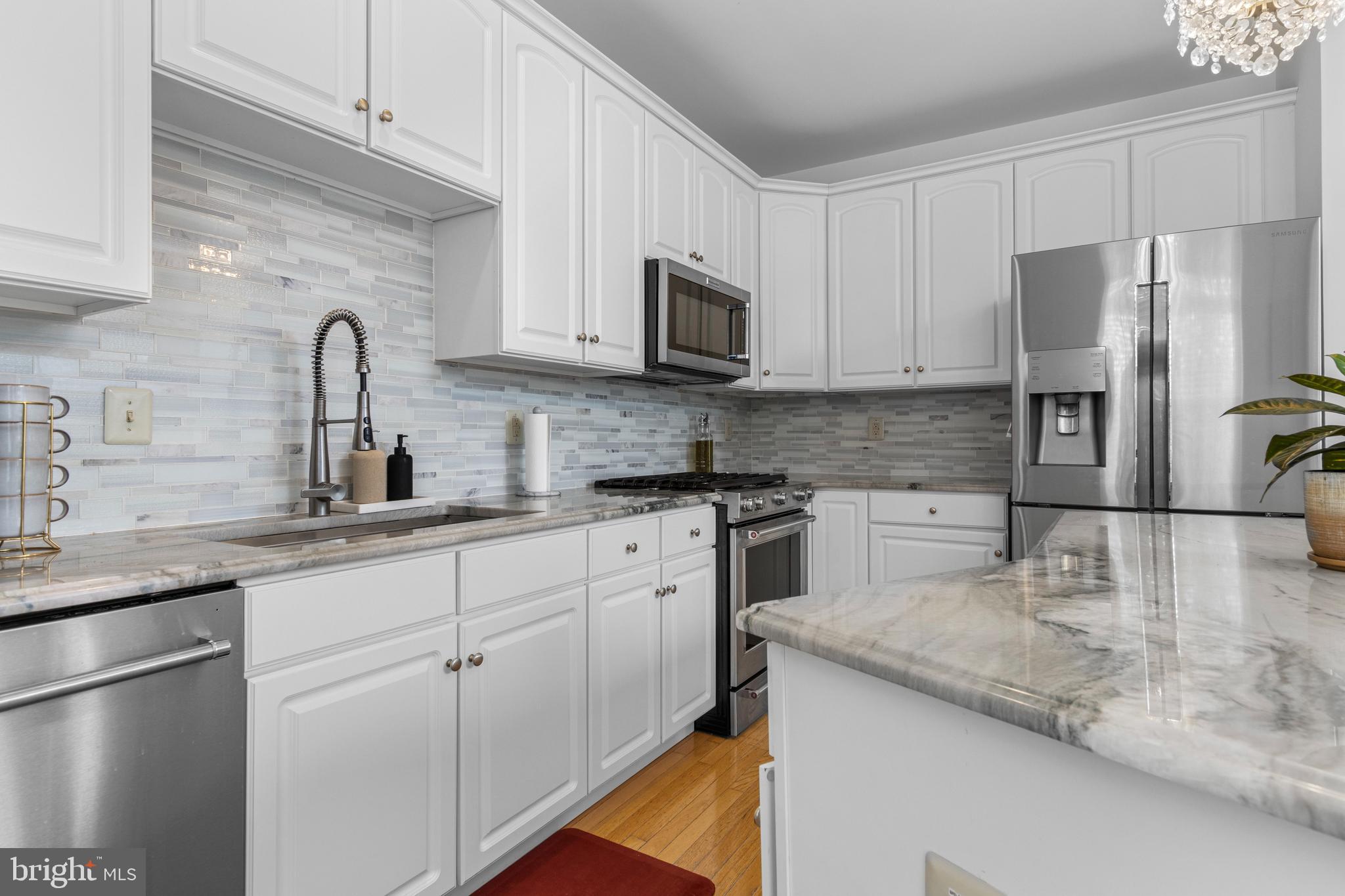 805 Hinchley Run West Chester, PA 19382 - Photo 29 of 53 a kitchen with granite countertop white cabinets and stainless steel appliances