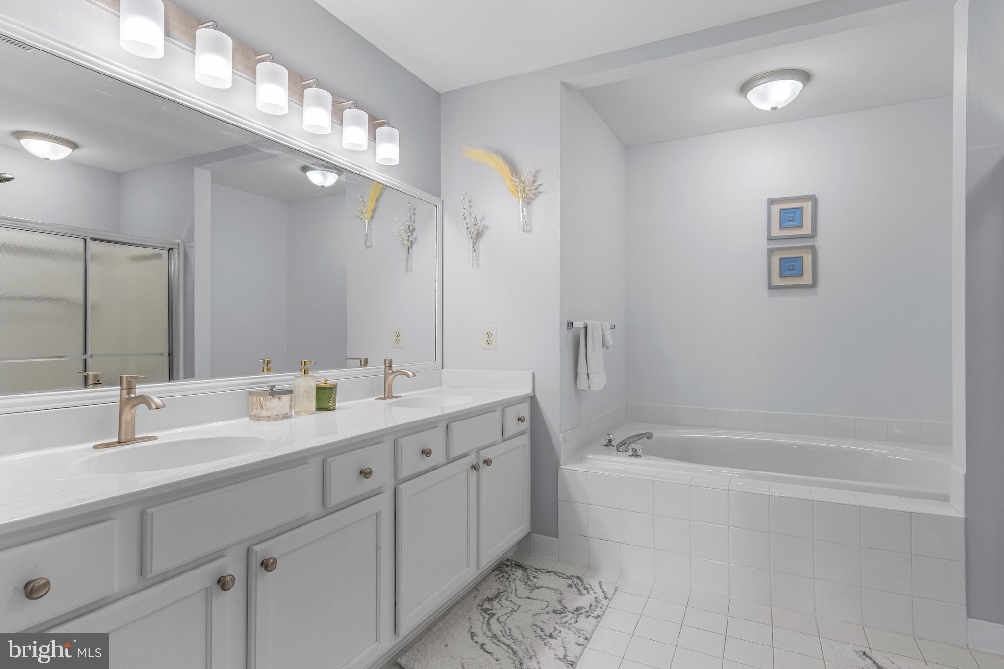 805 Hinchley Run West Chester, PA 19382 - Photo 44 of 53 a bathroom with a double vanity sink mirror and a bathtub