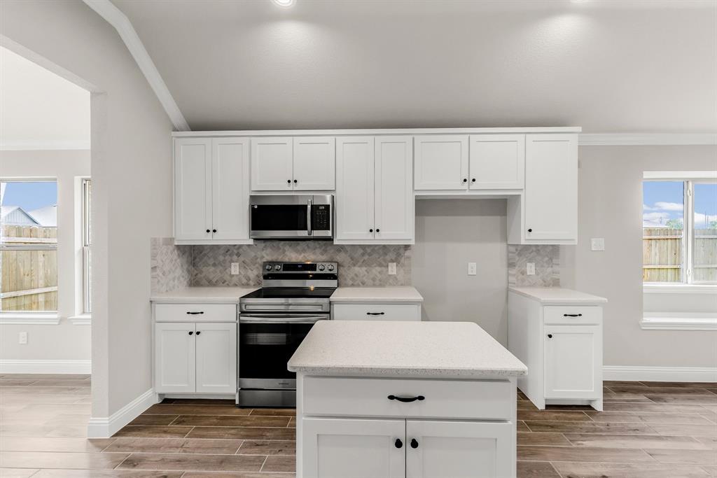 314 Pennington Road Josephine, TX 75173 - Photo 6 of 37 a kitchen with white cabinets and white appliances