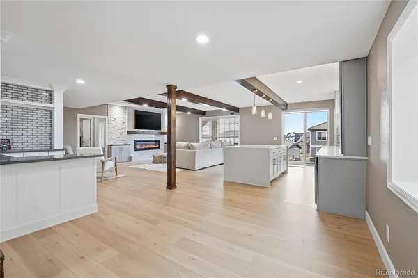 a view of a living room kitchen with furniture and wooden floor